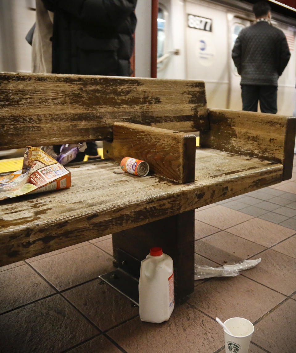 Trash collects around a bench on a subway platform, Thursday March 30, 2017, in New York. Faced with the problem of too much litter and too many rats in their subway stations, New York City transit officials began an unusual social experiment a few years ago. They removed trash bins entirely from select stations, figuring it would deter people from bringing garbage into the subway in the first place. This week, they pulled the plug on the program after reluctantly concluding that it was a failure. (AP Photo/Bebeto Matthews)