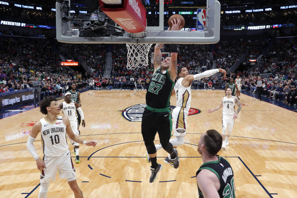 Boston Celtics center Daniel Theis (27) goes to the basket over New Orleans Pelicans center Jaxson Hayes (10) in the first half of an NBA basketball game in New Orleans, Sunday, Jan. 26, 2020. (AP Photo/Gerald Herbert)