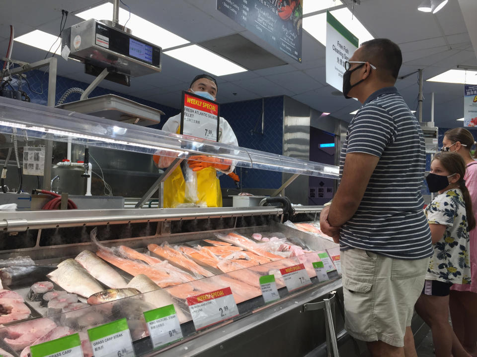 People purchase fish at a grocery store in Toronto, Ontario, Canada, on July 03, 2021. Canadian families can expect to pay $695 more for food in 2021 as food prices continue to rise across the country. (Photo by Creative Touch Imaging Ltd./NurPhoto via Getty Images)
