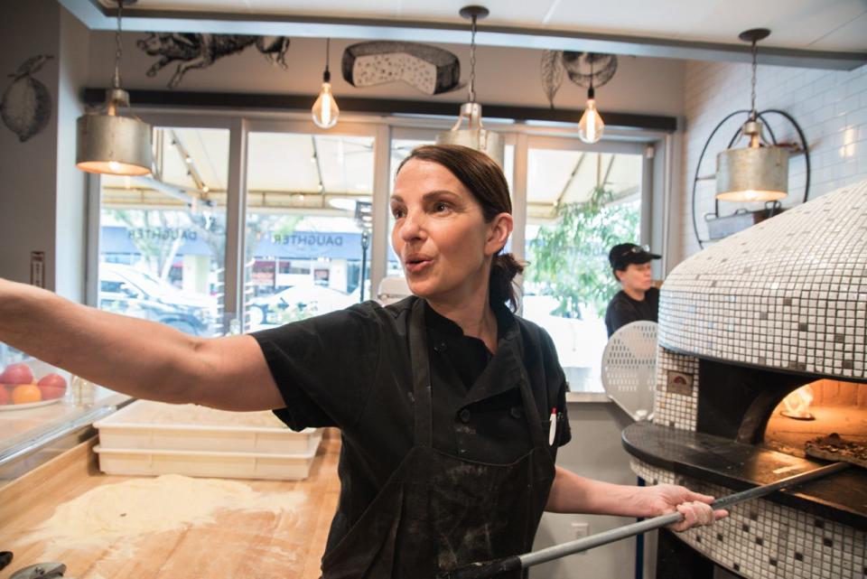 Chef/restaurateur Suzanne Perrotto, at her Rose's Daughter pizza oven in Delray Beach. Perrotto's Italian-American restaurant pays homage to her mom and culinary inspiration, Linda Rose.