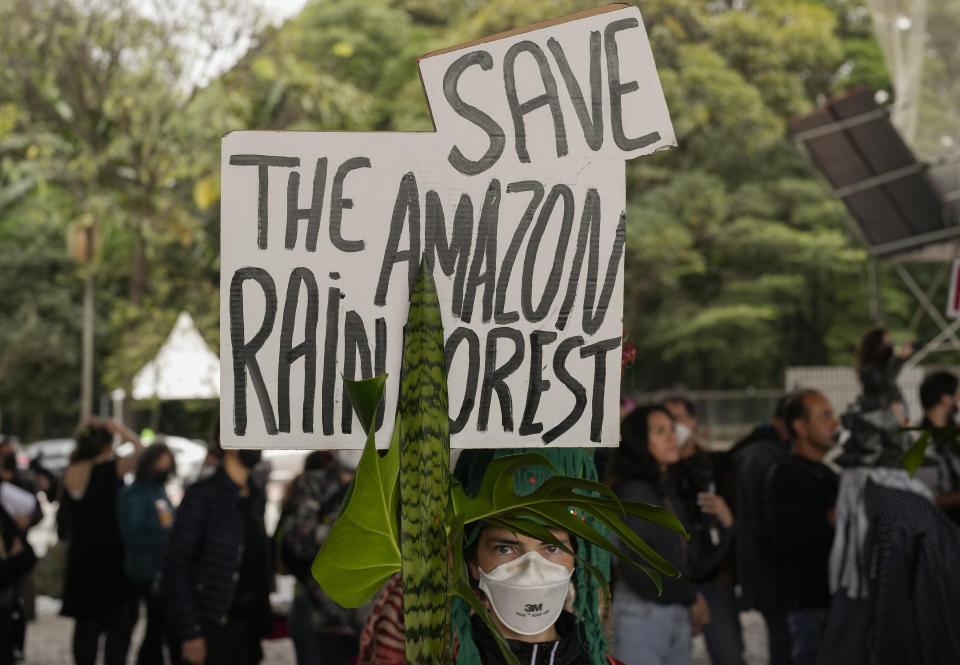 An activist takes part in a rally in support of British journalist Dom Phillips and Indigenous expert Bruno Perreira, demanding authorities conduct a thorough investigation into the circumstances leading to their deaths, and do more to protect indigenous lands against illegal miners, loggers, and fishermen, in Sao Paulo, Brazil, Saturday, June 18, 2022. (AP Photo/Andre Penner)