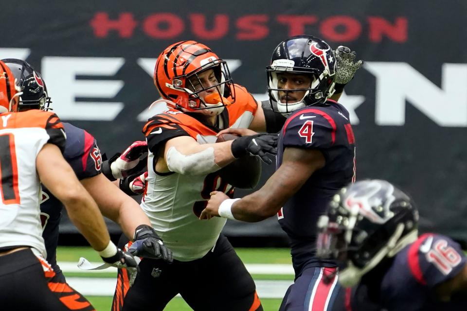 Houston Texans quarterback Deshaun Watson (4) fumbles the football as he is hit by Cincinnati Bengals' Sam Hubbard (94) during the second half of an NFL football game Sunday, Dec. 27, 2020, in Houston. The Bengals recovered the fumble.