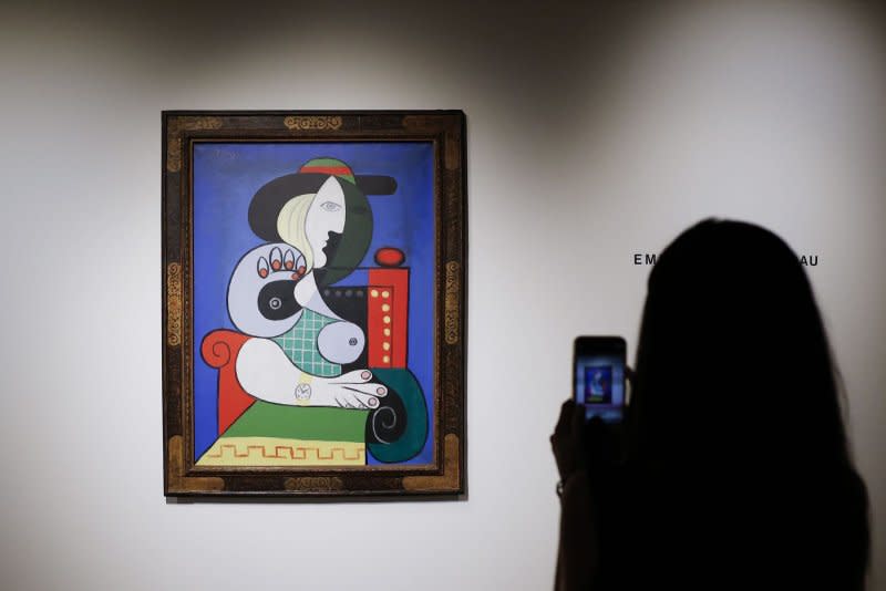 A viewer observers Femme a la montre, 1932 oil on canvas by Pablo Picasso, which is on display as part of the Emily Fisher Landau Collection at Sotheby's in New York on Wednesday. Photo by John Angelillo/UPI