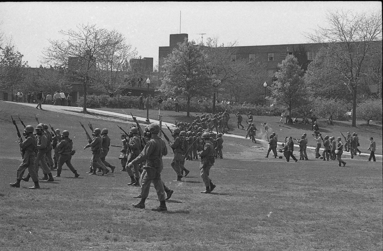 Ohio National Guardsmen wear gas masks while marching May 4, 1970, on the campus of Kent State University. Four students died and nine were wounded when the Guard opened fire during a Vietnam War protest.