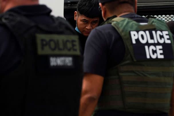 FILE PHOTO: A migrant who was previously detained gets off a van coming from Waco while U.S. ICE agents wait for everyone to get down so that their handcuffs can be removed to then be escorted to Mexico, in Laredo, Texas, U.S. June 15, 2022. (Veronica Cardenas/Reuters)