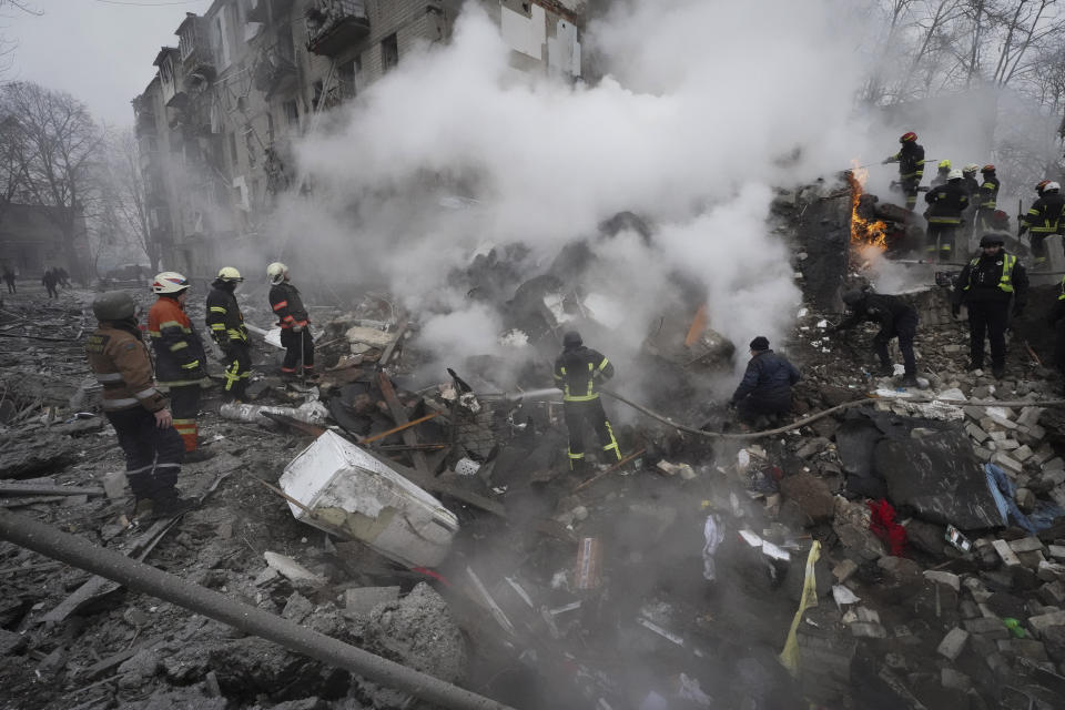 Rescuers work at the scene of a building damaged by Russian rocket attack in Kharkiv, Ukraine, Tuesday, Jan. 23, 2024. (AP Photo/Andrii Marienko)