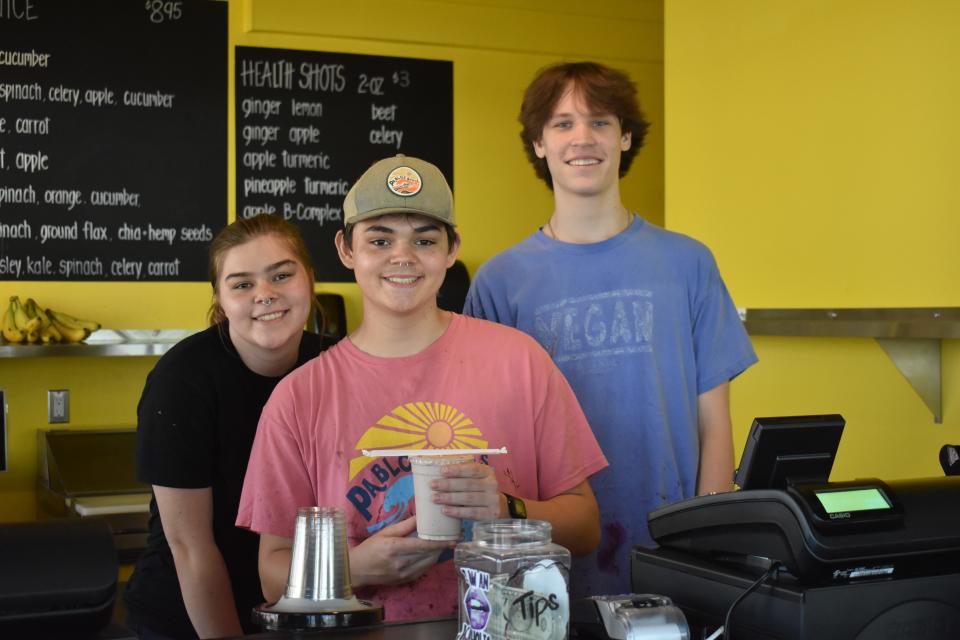 Pablo's Bowls Assistant Manager Hannah Snader (left) smiles with two other employees as they serve a customer on Saturday, May 28, 2022 in Ocean City, Maryland.