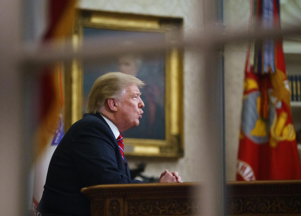 As seen from a window outside the Oval Office, President Donald Trump gives a prime-time address about border security Tuesday, Jan. 8, 2018, at the White House in Washington. (AP Photo/Carolyn Kaster)