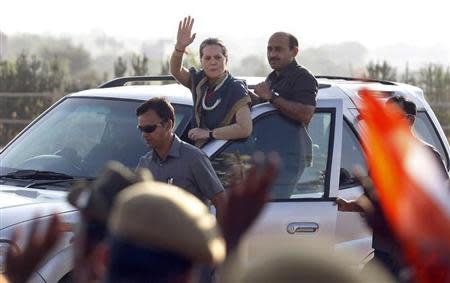 Chief of India's ruling Congress party Sonia Gandhi (C) waves towards her supporters from a vehicle after she addressed a rally ahead of the state elections in Dungarpur town, located in the desert Indian state of Rajasthan November 23, 2013. REUTERS/Amit Dave