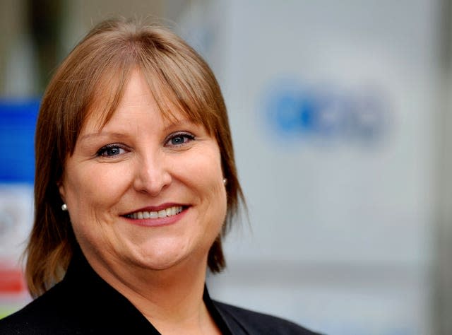 Woman with short brown hair smiling at the camera