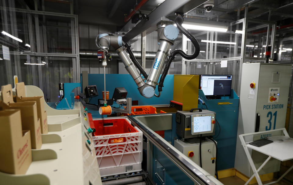 A robotic arm undergoes trials at the Ocado CFC (Customer Fulfilment Centre) in Andover, Britain May 1, 2018. Picture taken May 1, 2018.  REUTERS/Peter Nicholls