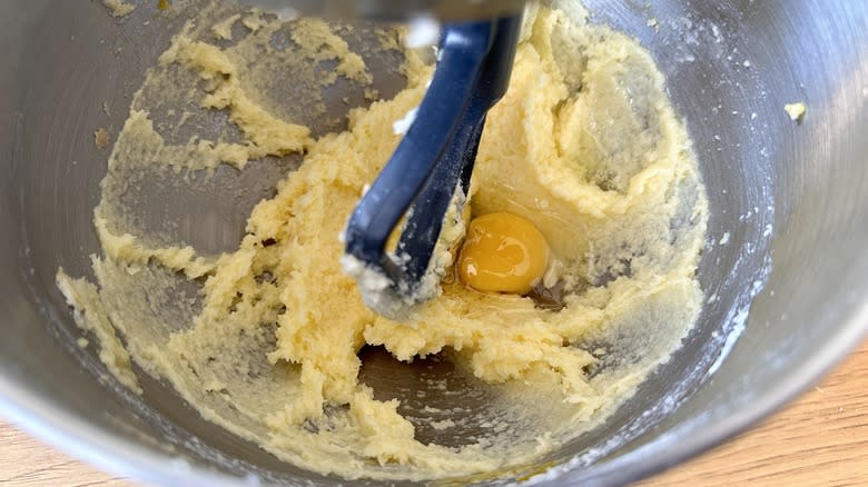 Adding eggs to creamed butter and sugar