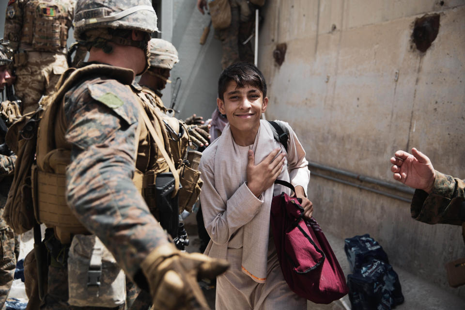 FILE - In this Wednesday, Aug. 18, 2021 file photo provided by the U.S. Marine Corps, a boy is processed through an Evacuee Control Checkpoint during an evacuation at Hamid Karzai International Airport, in Kabul, Afghanistan. (Staff Sgt. Victor Mancilla/U.S. Marine Corps via AP, File)