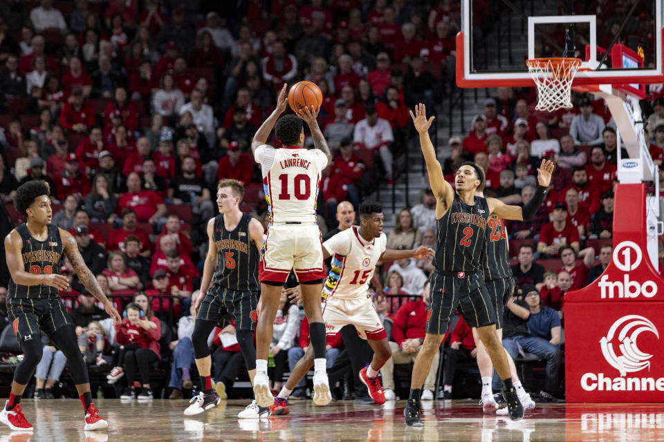 Nebraska's Jamarques Lawrence (10) makes a three point shot against Wisconsin's Jordan Davis (2) at the end of the second half during an NCAA college basketball game Saturday, Feb. 11, 2023, in Lincoln, Neb. (AP Photo/John Peterson)
