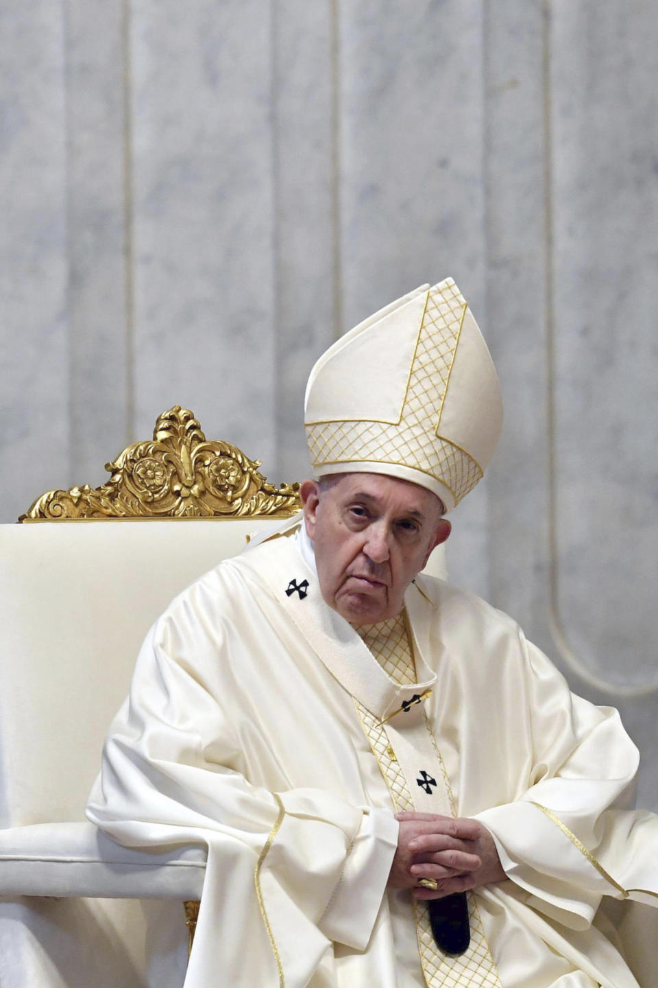 Pope Francis attends a Mass for Holy Thursday, inside St. Peter's Basilica at the Vatican, Thursday, April 9, 2020. Francis celebrated the Holy Week Mass in St. Peter's Basilica, which was largely empty of faithful because of restrictions aimed at containing the spread of COVID-19. The new coronavirus causes mild or moderate symptoms for most people, but for some, especially older adults and people with existing health problems, it can cause more severe illness or death. (Alessandro Di Meo/Pool Photo via AP)