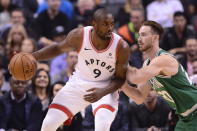 Toronto Raptors forward Serge Ibaka (9) controls the ball as Boston Celtics forward Gordon Hayward (20) applies pressure during first-half NBA basketball game action in Toronto, Friday, Oct. 19, 2018. (Frank Gunn/The Canadian Press via AP)