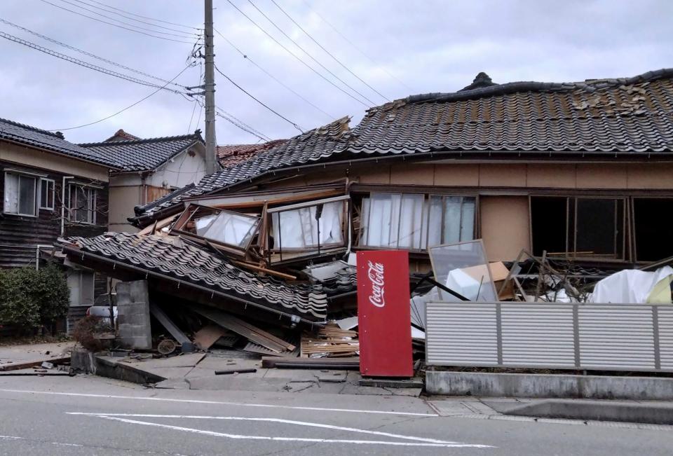 A house is damaged by an earthquake in Wajima, Ishikawa prefecture, Japan Monday, Jan. 1, 2024. Japan issued tsunami alerts Monday after a series of strong quakes in the Sea of Japan. (Kyodo News via AP)