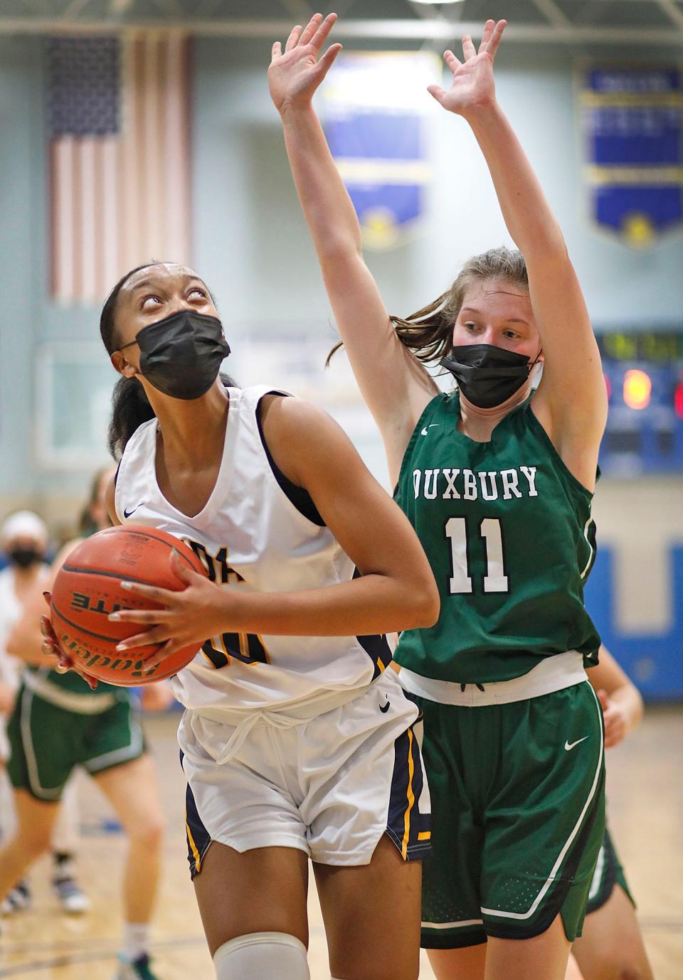 Notre Dame Academy's Kaylah Jacques set up for a shot as Duxbury's Lyla Peters looks to block. Notre Dame Academy hosts Duxbury girls basketball on Friday, Dec. 10, 2021.