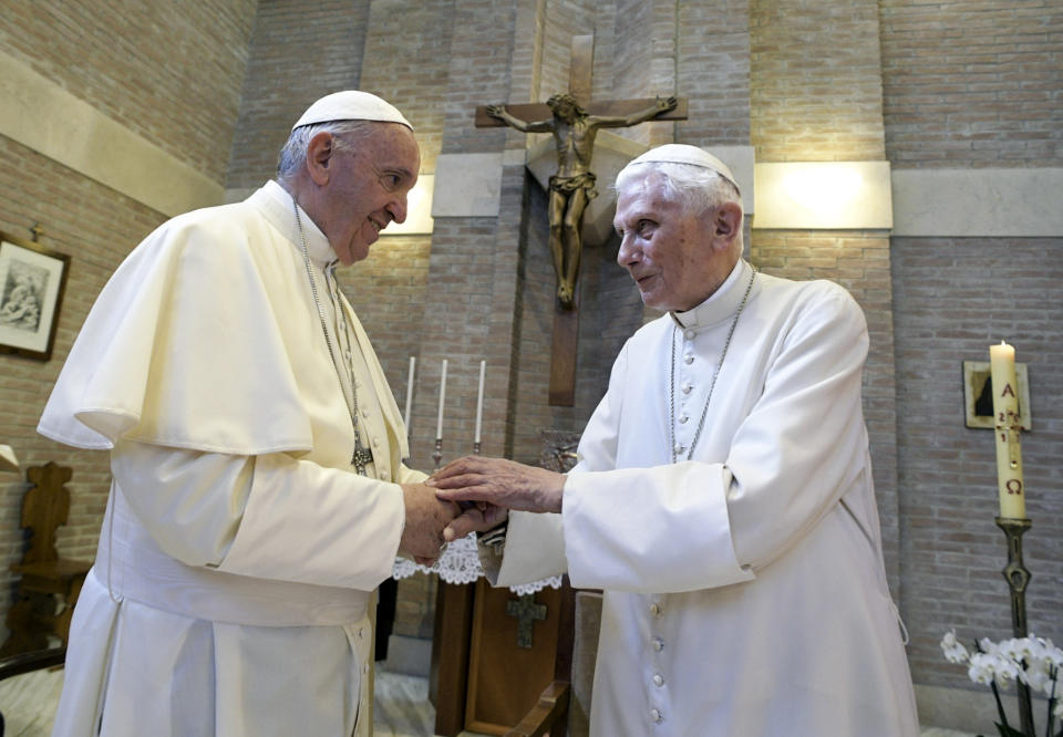 Pope Francis, left, and Pope Emeritus Benedict XVI, meet each other on the occasion of the elevation of five new cardinals, Louis-Marie Ling Mangkhanekhoun, Apostolic Vicary of Pakse, Laos, Anders Arborelius, Bishop of Stockholm, Sweden, Gregorio Rosa Chávez, Auxiliary of the dioceses of San Salvador, El Salvador, Juan José Omella, Archbishop of Barcelona Spain, and Jean Zerbo, Archbishop of Bamako, Malí, at the Vatican, Wednesday, June 28, 2017. (L'Osservatore Romano/Pool photo via AP)