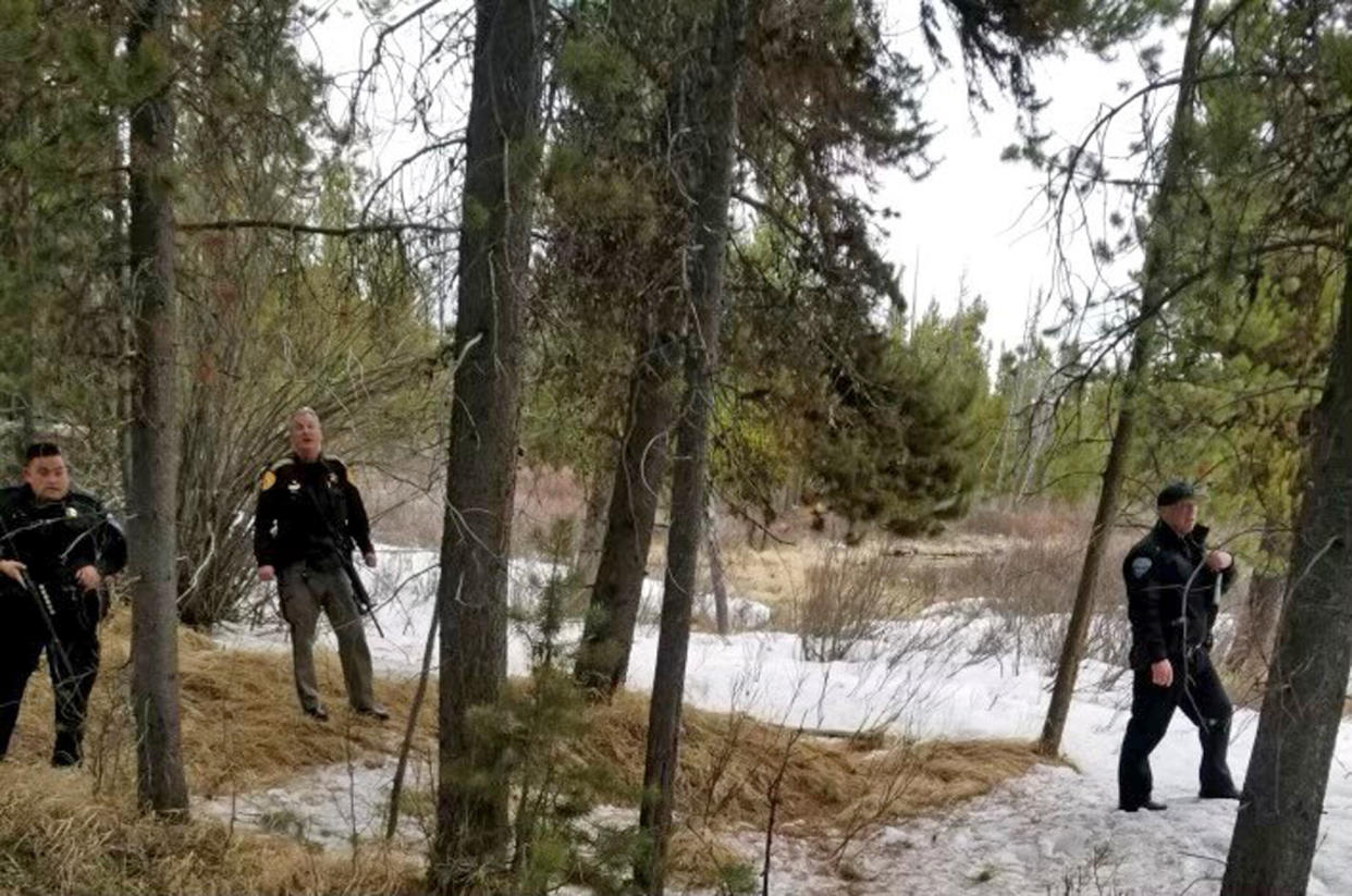 In this photo provided by the Gallatin County Sheriff's Office, officers from the sheriff's office and West Yellowstone Police Department are seen near the scene of a grizzly bear mauling just outside Yellowstone National Park near West Yellowstone, Mont. on April, 15, 2021. Authorities said Charles 