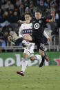 Minnesota United midfielder Will Trapp (20) controls the ball in front of Vancouver Whitecaps forward Simon Becher (29) in the second half of an MLS soccer game Saturday, March 25, 2023, in St. Paul, Minn. (AP Photo/Andy Clayton-King)