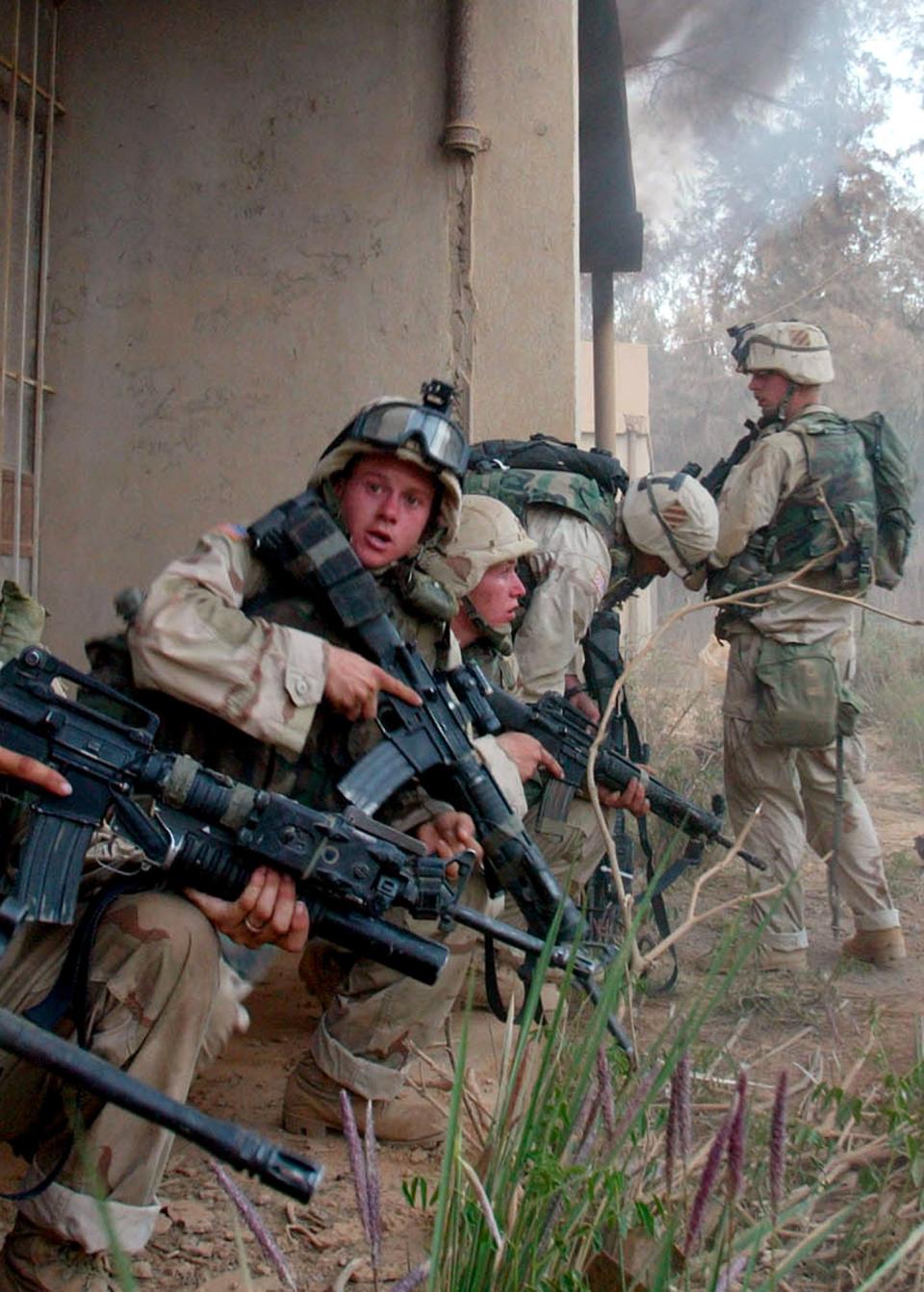 **RETRANSMITTED FOR ALTERNATE CROP** U.S. Army soldiers search buildings at an Iraqi military compound south of Baghdad Friday, April 4, 2003. Troops from A Company,  3rd Battalion, 7th Infantry Regiment searched the compound, destroying abandoned Iraqi military vehicles and helicopter parts.