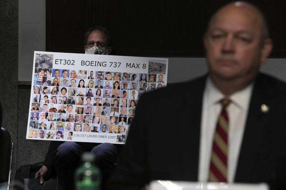 Michael Stumo holds a sign displaying photographs of the individuals who were killed in the March 10, 2019, crash of Ethiopian Airlines flight 302, as Federal Aviation Administration administrator Stephen Dickson testifies during a hearing of the Senate Commerce, Science, and Transportation Committee on Capitol Hill on Wednesday, June 17, 2020, in Washington. (Graeme Jennings/Pool via AP)