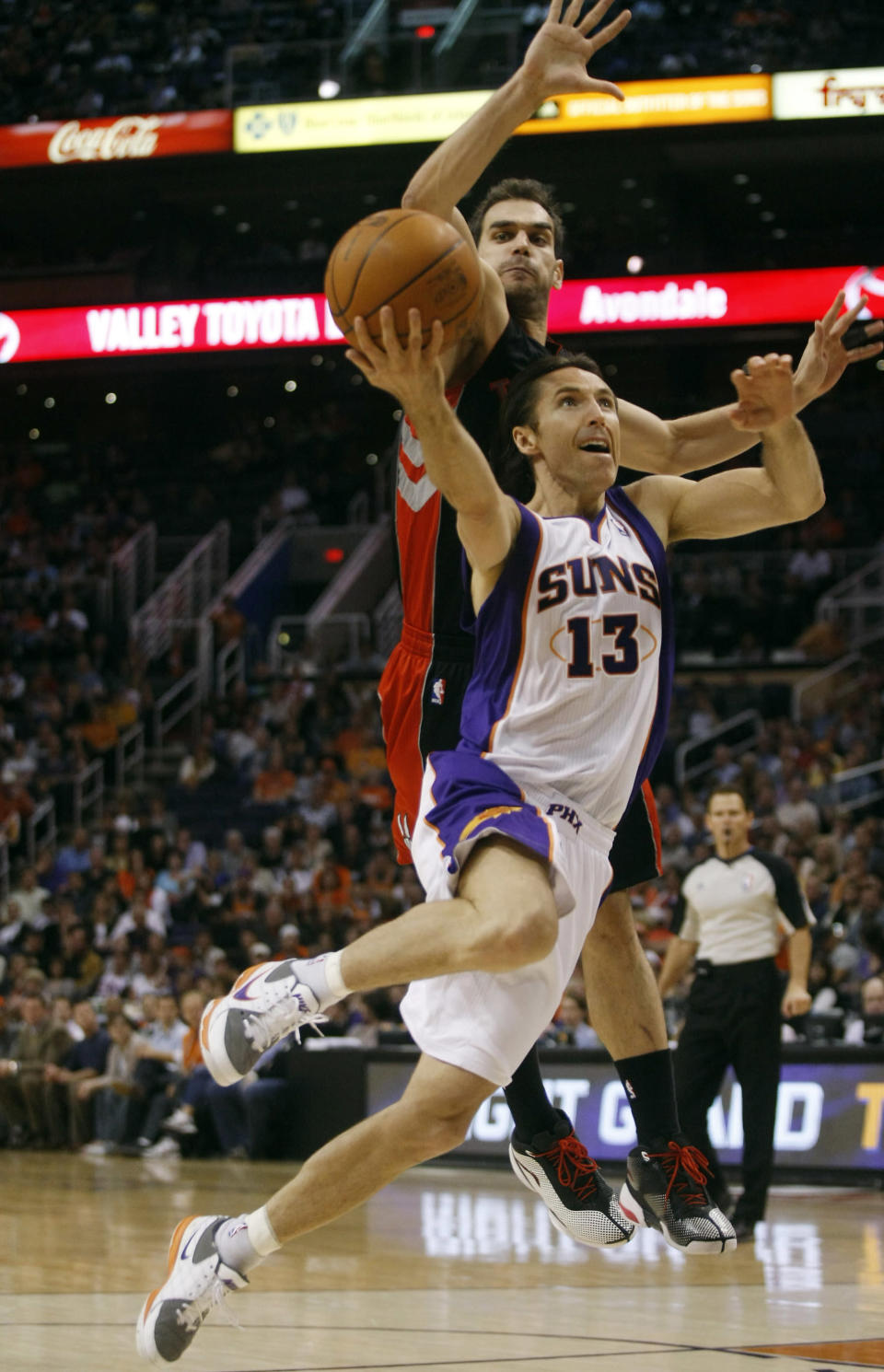 Toronto Raptors point guard Calderon blocks the shot of Phoenix Suns point guard Nash in the third quarter of an NBA basketball game. 2011. Reuters/ Images