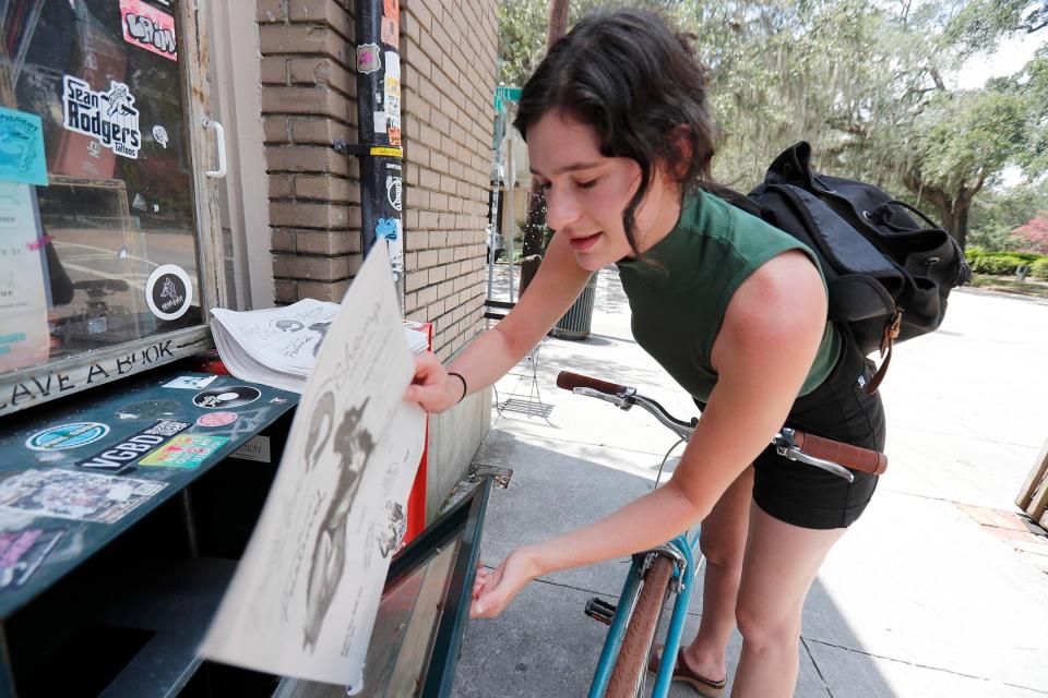 Carly Lieberman puts copies of her Peanut Butter Shrimp newspaper out near Brighter Day.