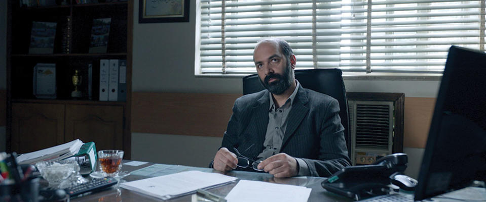 When Rahim gives the gold coins back to their owner, he is turned into a social media star by his prison governor (played by Mohammad Aghebati). - Credit: Amirhossein Shojaei/Amazon Studios