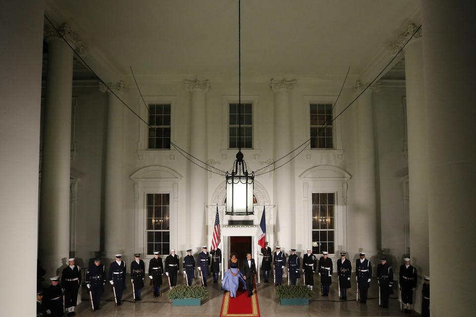 U.S. President Barack Obama and his wife Michelle walk out to greet French President Francois Hollande as he arrives for a State Dinner in his honor at the White House in Washington, February 11, 2014. (REUTERS/Jonathan Ernst)