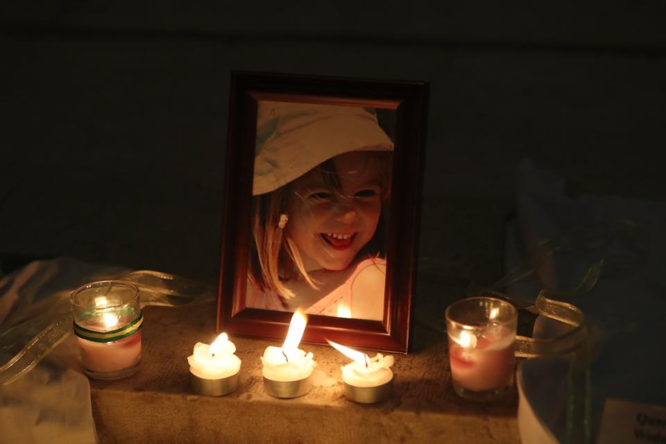 Candles light a photograph of Madeleine McCann inside the church of Praia da Luz, near Lagos, on May 3, 2017, during a mass ceremony marking the 10th anniversary of her disappearance. (Photo: STRINGER via Getty Images)