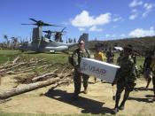 U.S. Marine Capt. Joseph White (L) and Philippine Army PFC Vic D. Victorlano unload U.S. aid from an Osprey aircraft as part of relief efforts after Typhoon Haiyan, in Pasay, Luzon province in the Philippines November 18, 2013. The Philippines is facing an enormous rebuilding task from Typhoon Haiyan, which killed at least 3,974 people and left 1,186 missing, with many isolated communities yet to receive significant aid despite a massive international relief effort. Picture taken November 18, 2013. REUTERS/US Marines/Handout via Reuters (PHILIPPINES - Tags: MILITARY DISASTER POLITICS) ATTENTION EDITORS - THIS IMAGE HAS BEEN SUPPLIED BY A THIRD PARTY. IT IS DISTRIBUTED, EXACTLY AS RECEIVED BY REUTERS, AS A SERVICE TO CLIENTS. FOR EDITORIAL USE ONLY. NOT FOR SALE FOR MARKETING OR ADVERTISING CAMPAIGNS