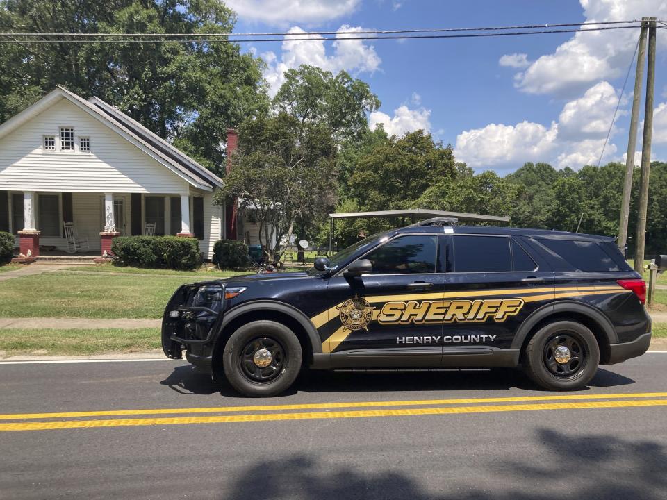 A Henry County sheriff's deputy leaves a meeting to discuss the manhunt for Andre Longmore in Hampton, Ga., on Sunday, July 16, 2023. Police say Longmore shot and killed four people in a nearby neighborhood on Saturday, July 15, 2023. (AP Photo/Jeff Amy)