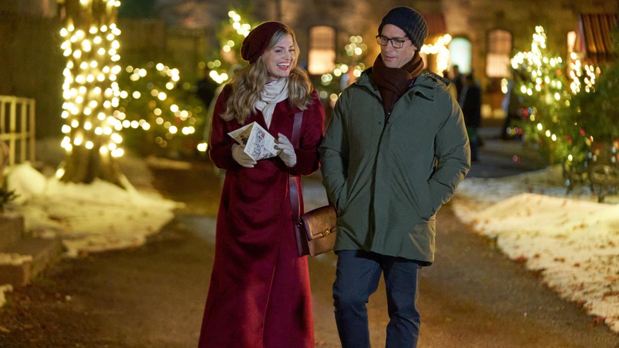 Brooke D'Orsay, Will Kemp walk together on a snowy path in A Not So Royal Christmas. 