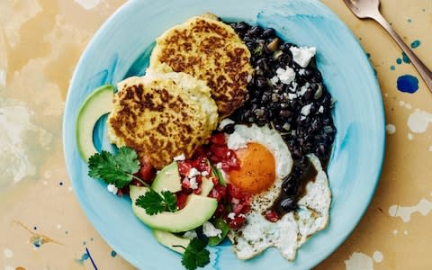 Gooey cheesy middle sweetcorn cakes with avocado, eggs and salsa - Credit: Haarala Hamilton