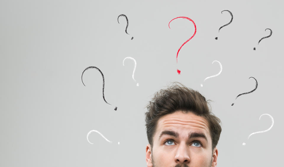 Confused man with question marks above his head