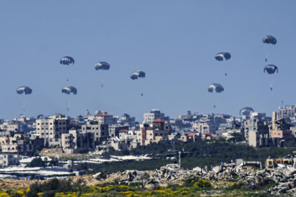 Parachutes drop supplies into the northern Gaza Strip, as seen from southern Israel , Sunday, March 10, 2024. (AP Photo/Ariel Schalit)