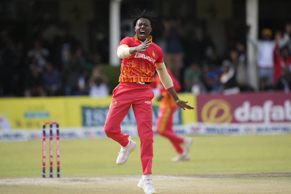 Zimbabwean's bowler Victor Nyauchi , right, celebrates after taking the wicket of Bangladesh's batsman on the final day of the T20 match between Zimbabwe and Bangladesh at Harare Sports Club in Harare, Zimbabwe, Tuesday, Aug. 2, 2022. (AP Photo/Tsvangirayi Mukwazhi)