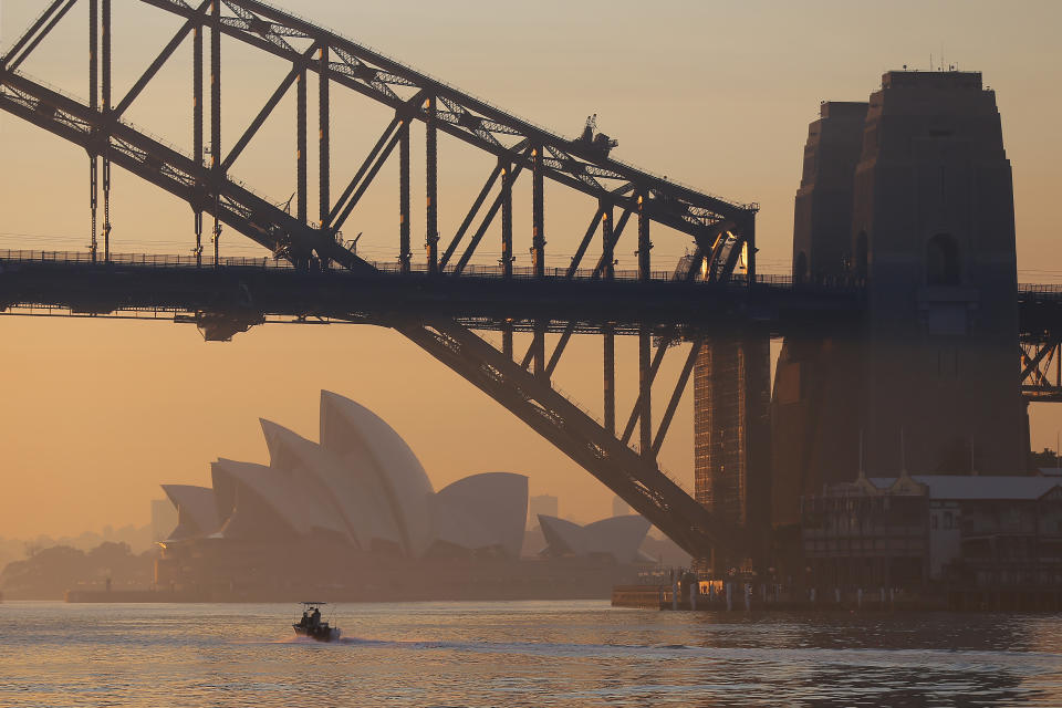 The Sydney Harbour Bridge and Sydney Opera House covered in smoke. 