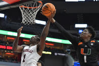 Miami forward Anthony Walker (1) attempts to block the shot of Louisville guard Mike James (1) during the second half of an NCAA college basketball game in Louisville, Ky., Sunday, Dec. 4, 2022. Miami won 80-53. (AP Photo/Timothy D. Easley)