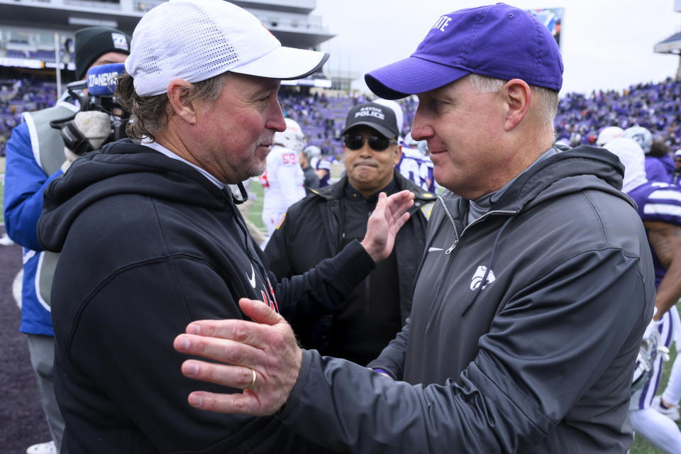 Houston head coach Dana Holgorsen, left, meets with Kansas State head coach Chris Klieman, right, after their NCAA college football game in Manhattan, Kan., Saturday, Oct. 28, 2023. Kansas State won, 41-0. (AP Photo/Reed Hoffmann)