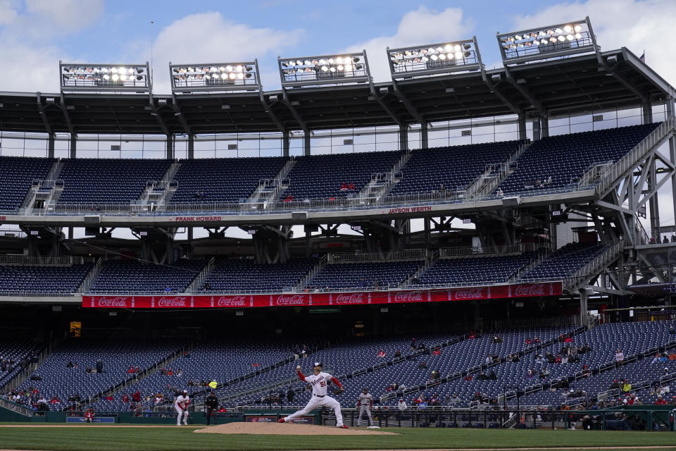 Washington Nationals relief pitcher Austin Voth throws during the ninth inning in the first game of a baseball doubleheader against the Arizona Diamondbacks with only a few fans in Nationals Park, Tuesday, April 19, 2022, in Washington. The Nationals won the first game 6-1. (AP Photo/Alex Brandon)