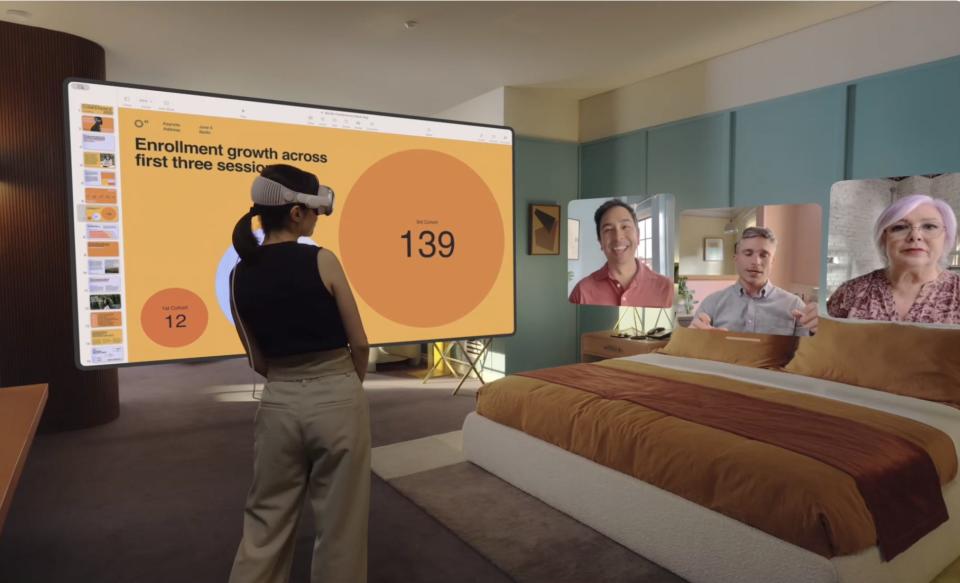 An image showing a Vision Pro user taking a video call while also viewing a work presentation.