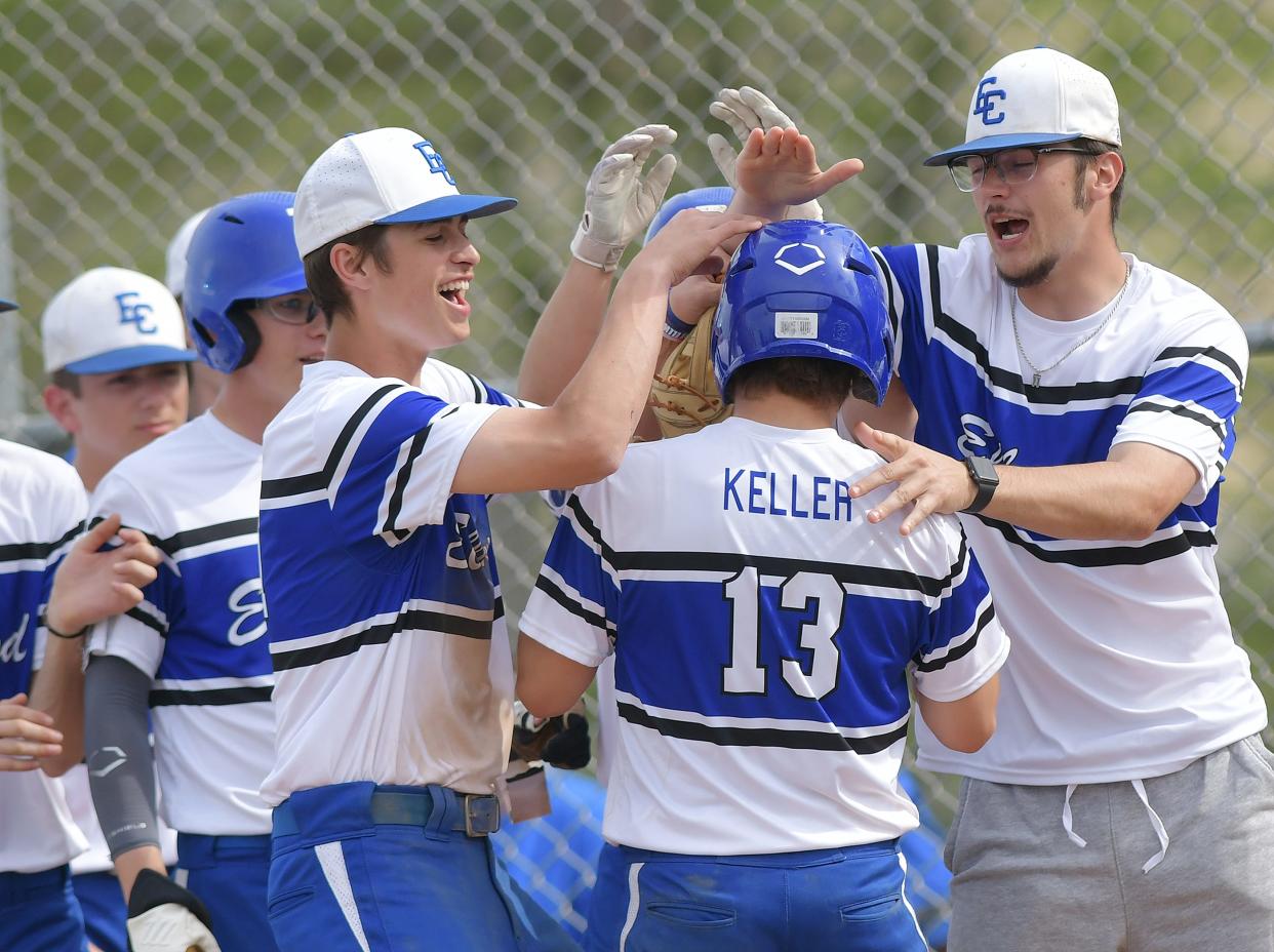 Ellwood's Jordan Keller is greeted by his teammates after hitting a home run during Friday's game at Western Beaver High School.