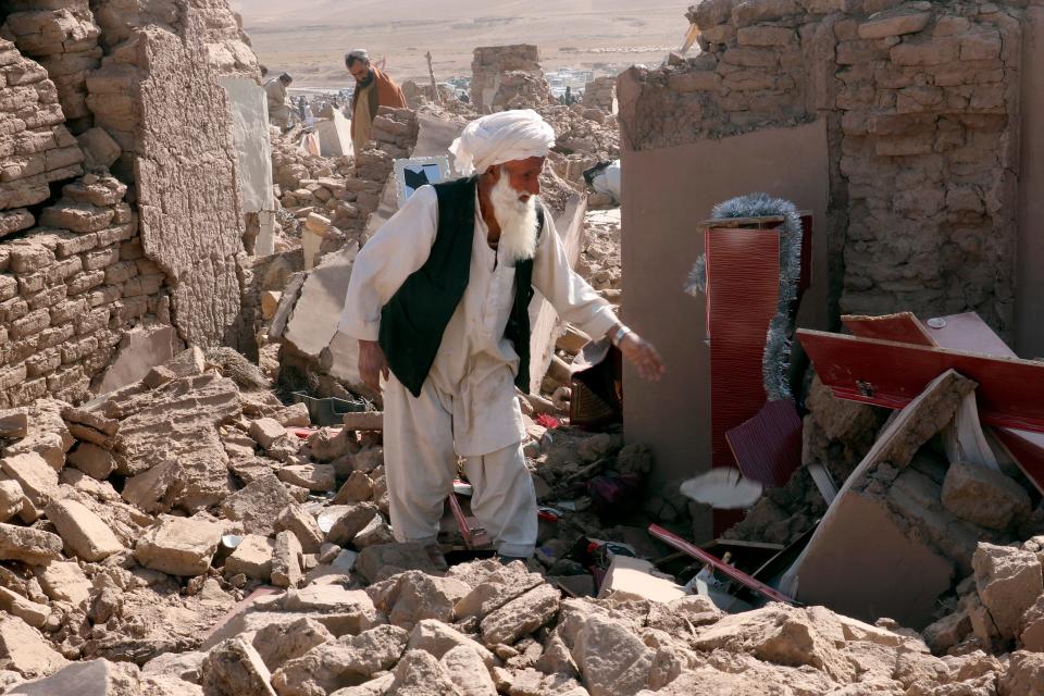 A man cleans up after an earthquake in Zenda Jan district in Herat province, of western Afghanistan, Sunday, Oct. 8, 2023. Powerful earthquakes killed at least 2,000 people in western Afghanistan, a Taliban government spokesman said Sunday. It's one of the deadliest earthquakes to strike the country in two decades. (AP Photo/Omid Haqjoo)