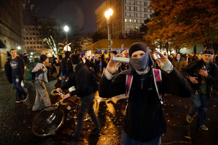 A demonstrator holds up cartridges during a protest against the election of Republican Donald Trump as President of the United States in Portland, Oregon, U.S. November 12, 2016. REUTERS/William Gagan