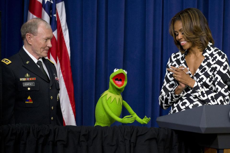 Gen. Martin Dempsey, chairman of the Joint Chiefs of Staff, left, Kermit the Frog, and first lady Michelle Obama, speak to children of military families in the South Court Auditorium of the Eisenhower Executive Office Building on the White House complex, Wednesday, March 12, 2014, before a screening of Disney’s "Muppets Most Wanted" movie as part of the Joining Forces initiative. (AP Photo/Jacquelyn Martin)