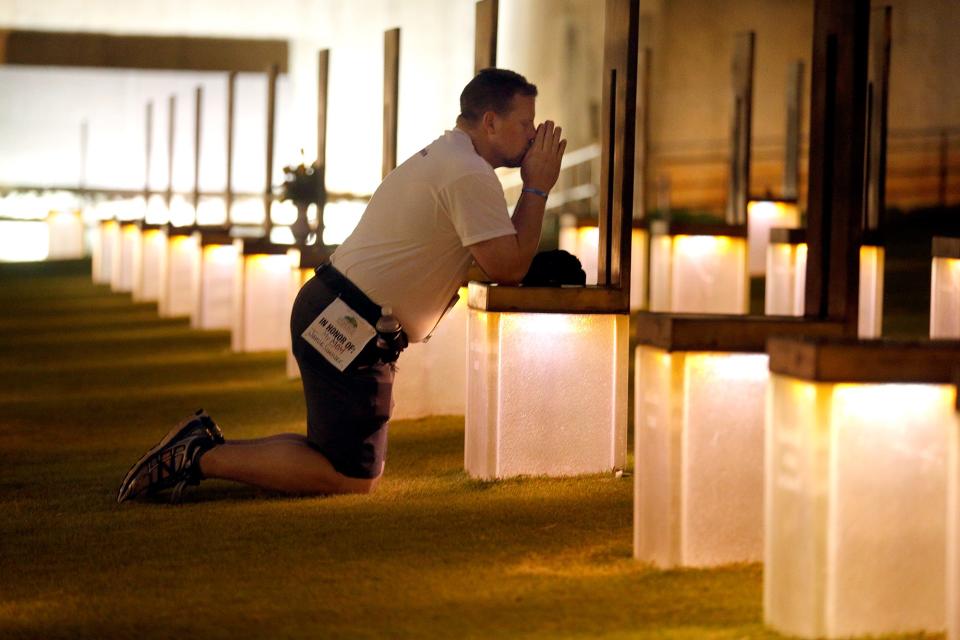 â€šÃ„ÃºI run, it helps to clear my mind. And then I run this especially to honor my mom and all the167 others that passed away 20 years ago," Kyle Genzer said after praying at the chair honoring his mother, Jamie (Fialkowski) Genzer, before the 15th Annual Oklahoma City Memorial Marathon, Sunday, April, 26, 2015. "I did (start running) five years ago because it was the first year I lived longer without my mom than I did with her. So that is when I started." As for what the marathon and 20 year anniversary means to him, he said, "A long time without my mom and just the struggles that life is on a daily basis." Photo by Sarah Phipps, The Oklahoman