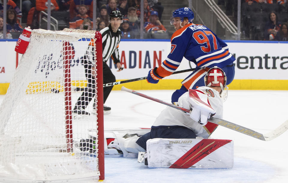 Florida Panthers goalie Spencer Knight, foreground, is scored against by Edmonton Oilers' Connor McDavid (97) during second-period NHL hockey game action in Edmonton, Alberta, Monday, Nov. 28, 2022. (Jason Franson/The Canadian Press via AP)